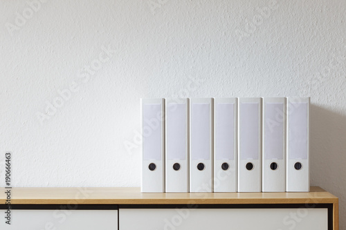 File folder on modern sideboard in bright room