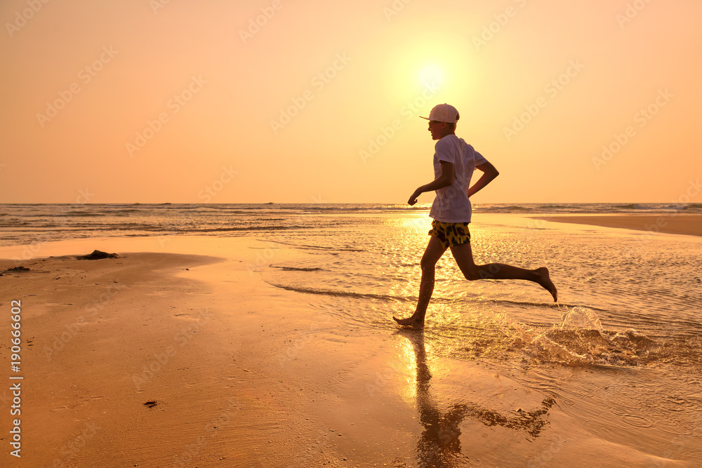 Young man training on the beach in morning. 