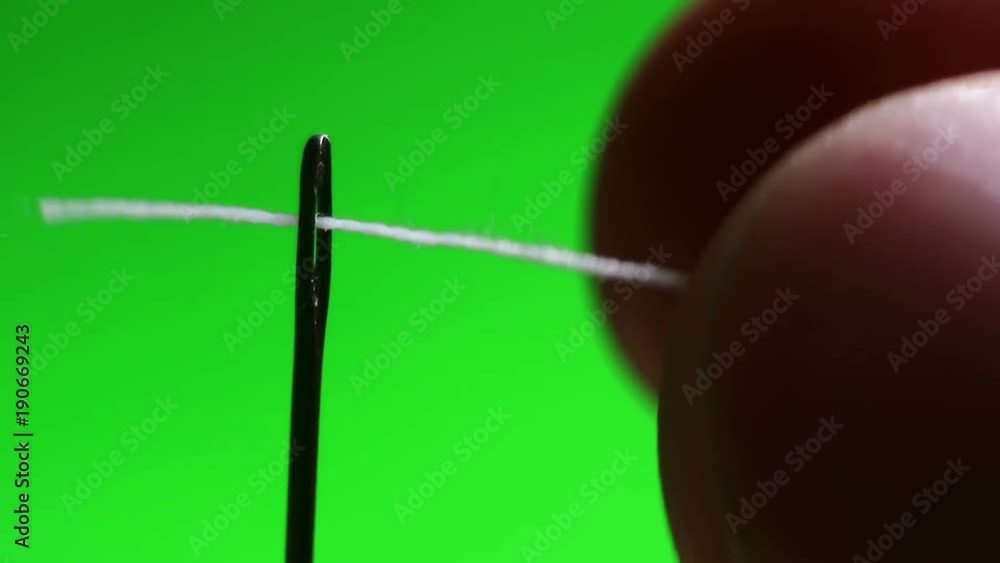 Needle with thread close-up. The designer of clothes pricked a needle. Hit the target Needle with thread close-up. The designer of clothes pricked a needle. Hit the target