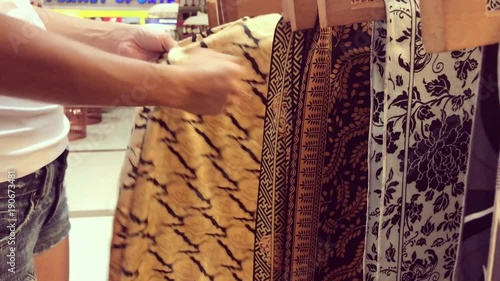 Woman selecting silk in the store. Bali shopping mall, Indnonesia.