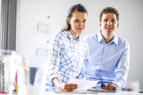 Portrait of business people working at desk in office