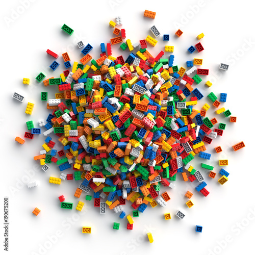 Pile of colored toy bricks isolated on white background. Lots of multicolored toy bricks for a children's theme or banner