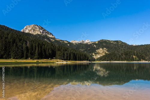 Black lake "Crno jezero" with reflections of Meded Peak in the crystal clear water, Durmitor National Park, Montenegro, Europe