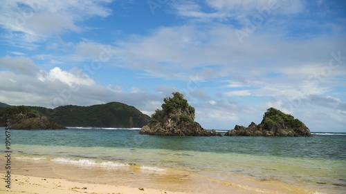 Fototapeta Naklejka Na Ścianę i Meble -  Seascape with beach, rocks and wave, sky, clouds, rocks, ocean. Puraran. 4K video Philippines Catanduanes Travel concept