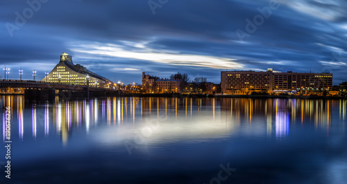 Riga skyline with National Library. Night shot with scenic water reflections in Daugava river waters