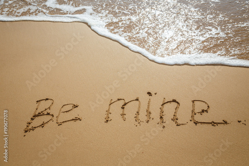 The inscription on the sand. Inscription on the bank of the ocean"be mine".