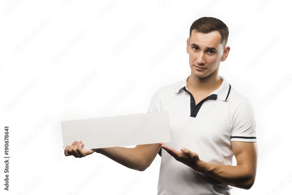 A young man holds an empty plate in his hands to fill your text. Emotional, courageous face. Isolated on white background. Copy space A young man holds an empty plate in his hands to fill your text. Emotional, courageous face. Isolated on white background. Copy space