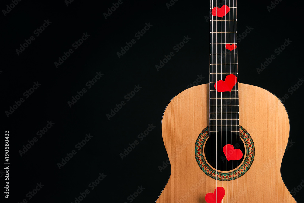 Red hearts on the strings of a guitar Red hearts on the strings of a guitar