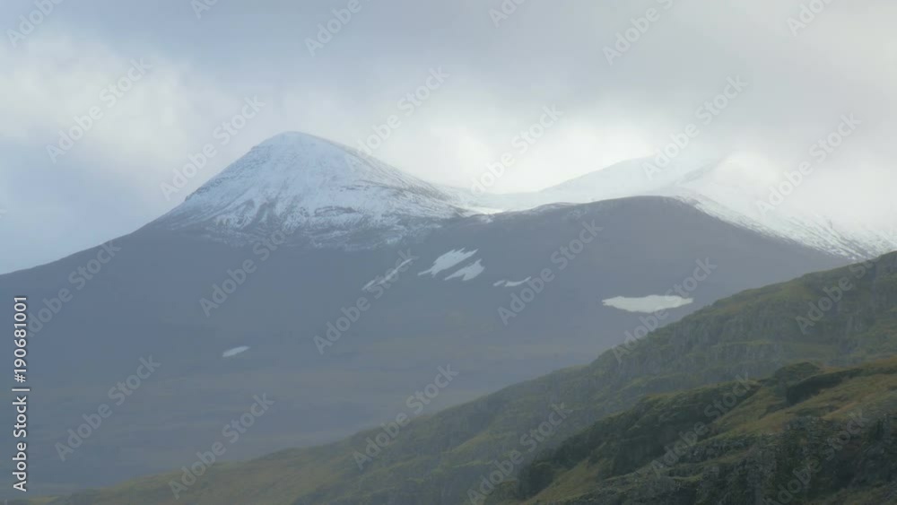 snow-capped mountains in Iceland, close-up of tops, rainy clouds is moving over snow-capped mountains in Iceland, close-up of tops, rainy clouds is moving over