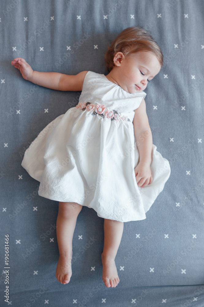Portrait of cute adorable smiling Caucasian blonde baby girl one