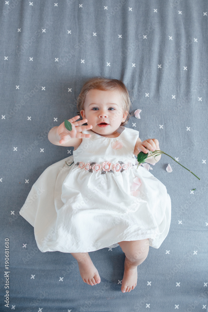 Portrait of cute adorable smiling Caucasian blonde baby girl one