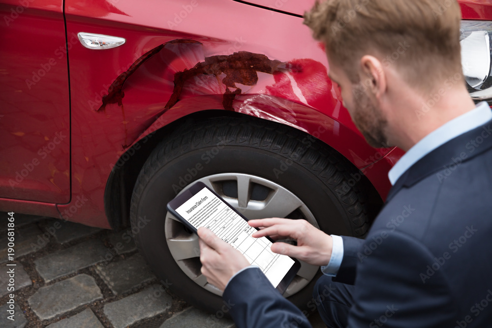 Man Looking At Digital Tablet Near Car Man Looking At Digital Tablet Near Car
