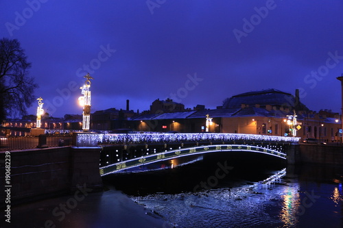 Russia, St. Petersburg, Panteleimon bridge in the evening with reflection in water