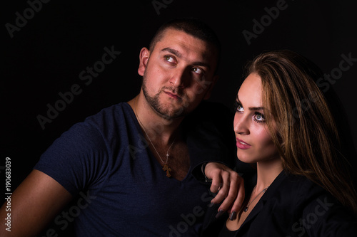 The guy and the girl pose in the studio
