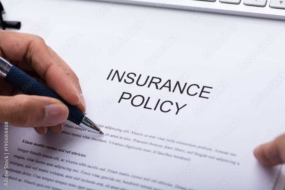 Person Filling Insurance Policy Form Person Filling Insurance Policy Form