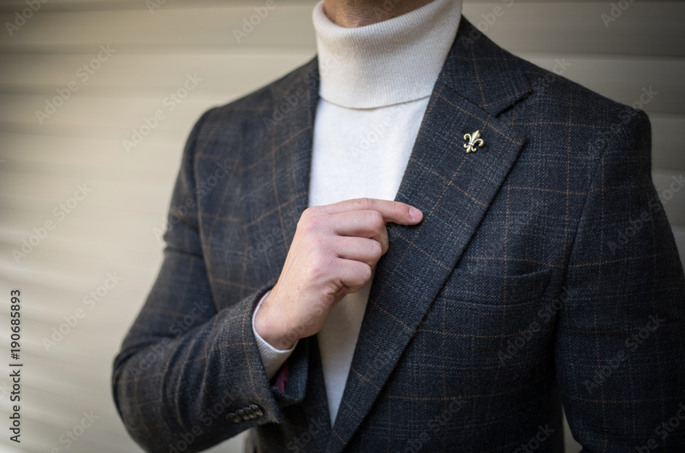 Man in turtleneck sweater suit holding his lapel and posing Stock Photo |  Adobe Stock