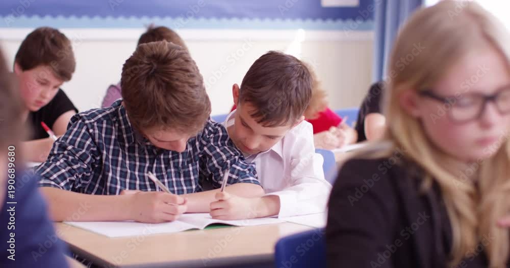 4k, Two students helping each other in a school classroom. Slow motion. 4k, Two students helping each other in a school classroom. Slow motion.