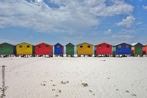 Brightly colored Victorian beach cabin houses on the Muizenberg Beach in Cape Town, South Africa © eqroy