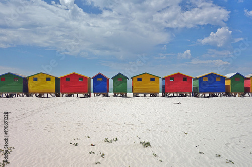 Brightly colored Victorian beach cabin houses on the Muizenberg Beach in Cape Town, South Africa photo