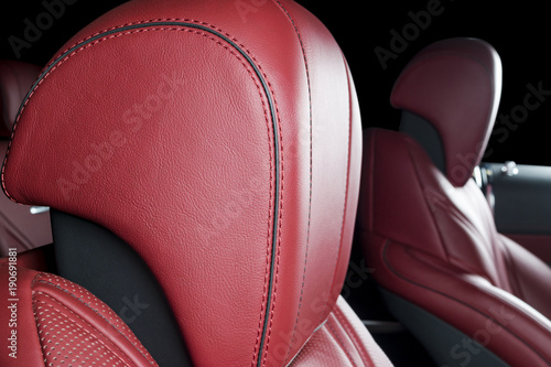 Modern Luxury car inside. Interior of prestige modern car. Comfortable leather red seats. Red perforated leather. Modern car interior details © Aleksei