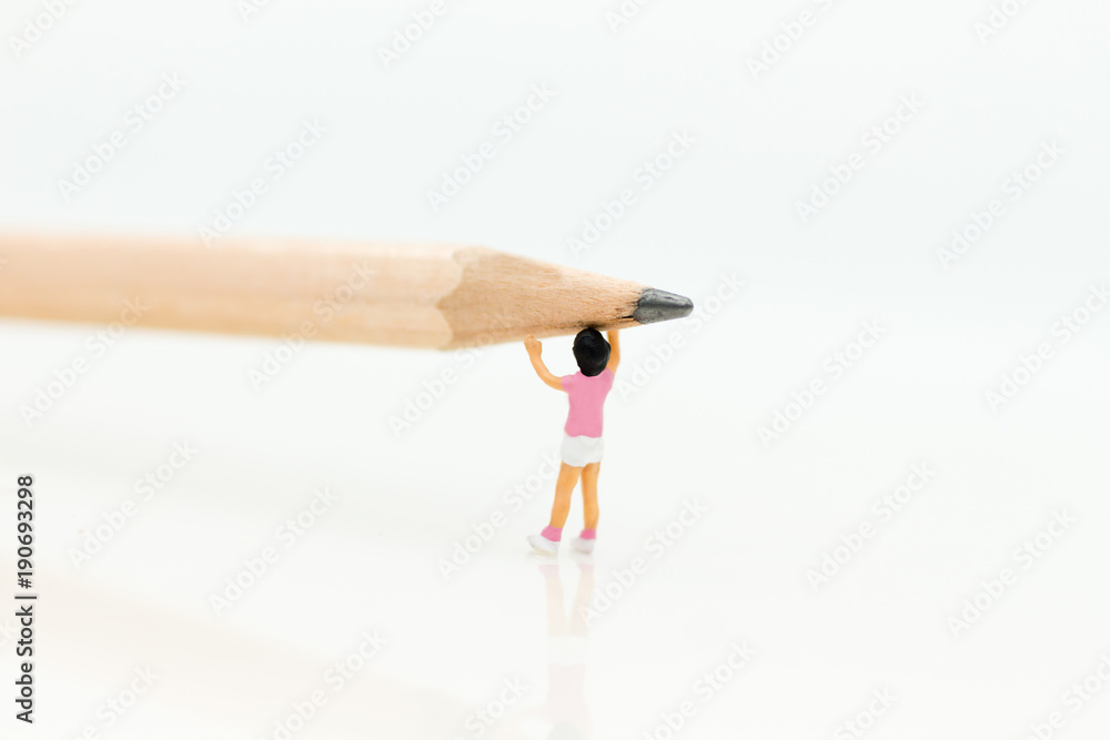 Miniature people: Boy is holding a pencil. Image use for education concept.