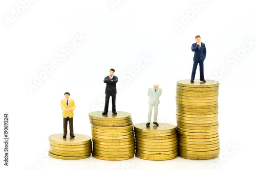 Miniature people : Group Businessman stands on a higher coins. Image use for business concept.