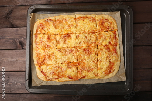 homemade pizza on wooden table