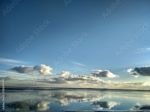 Reflections in the water on a sunny day at Wilhelmshaven Beach  Suedstrand