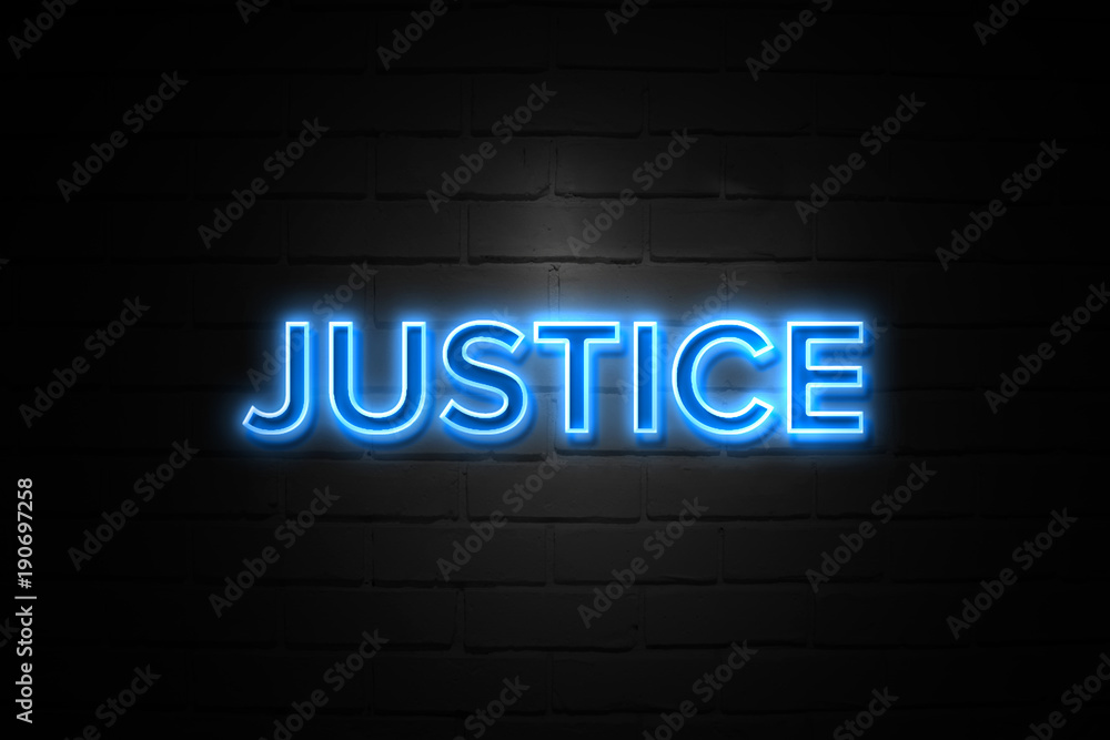 Justice neon Sign on brickwall