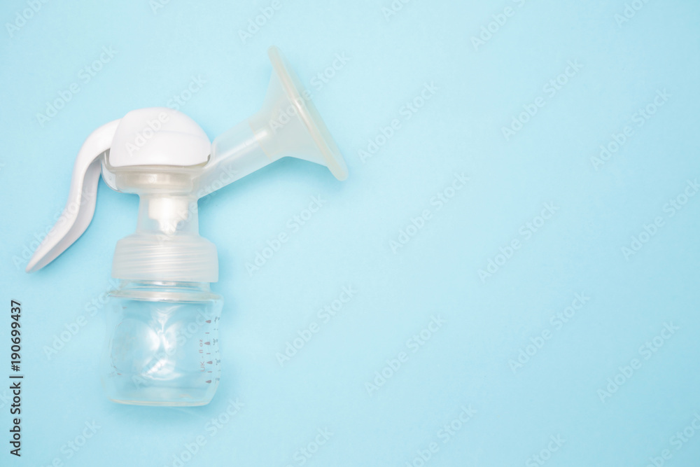 Manual breast pump with breast pads on the blue background Manual breast pump with breast pads on the blue background