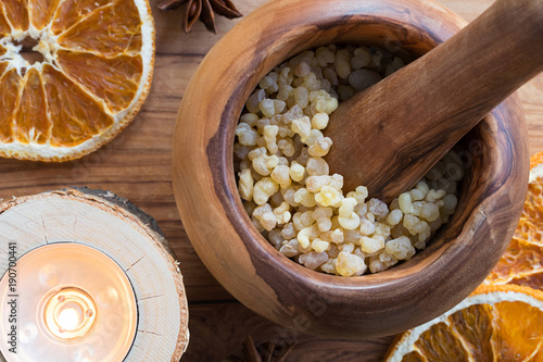 Frankincense resin in a mortar with a candle