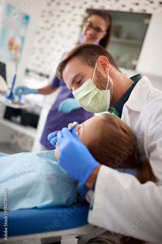 Dentist repairing girls tooth