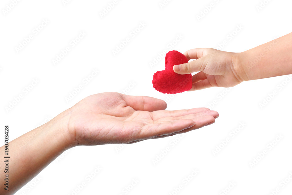 Baby's hand giving a red heart to mother's hand / Love and care between kid and mom / Mother's day concept Baby's hand giving a red heart to mother's hand / Love and care between kid and mom / Mother's day concept