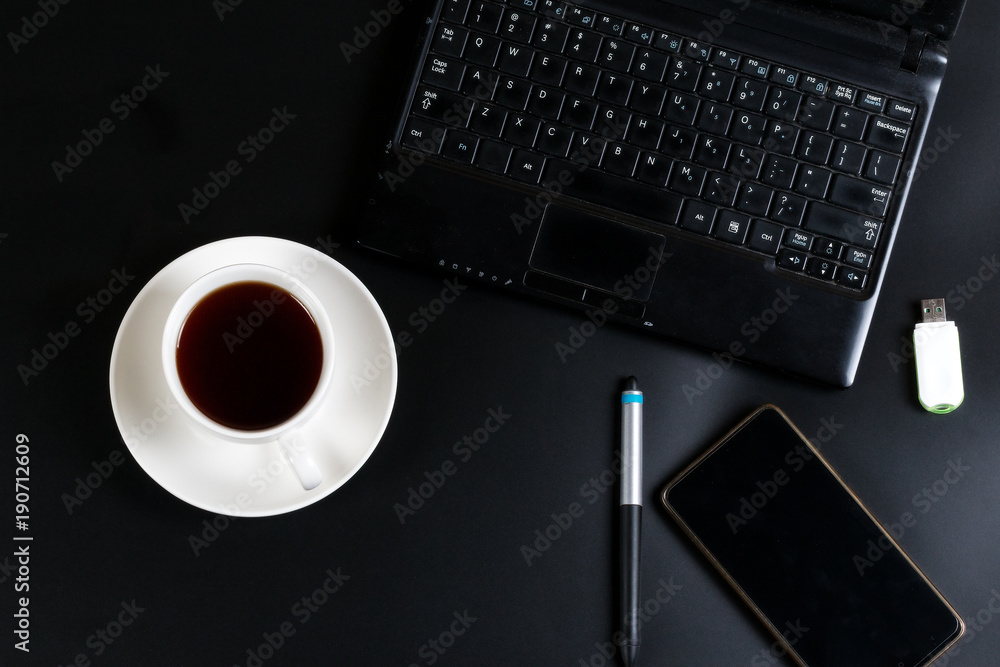 laptop phone cup of tea and biscuits with a bitcoin sign on the table laptop phone cup of tea and biscuits with a bitcoin sign on the table