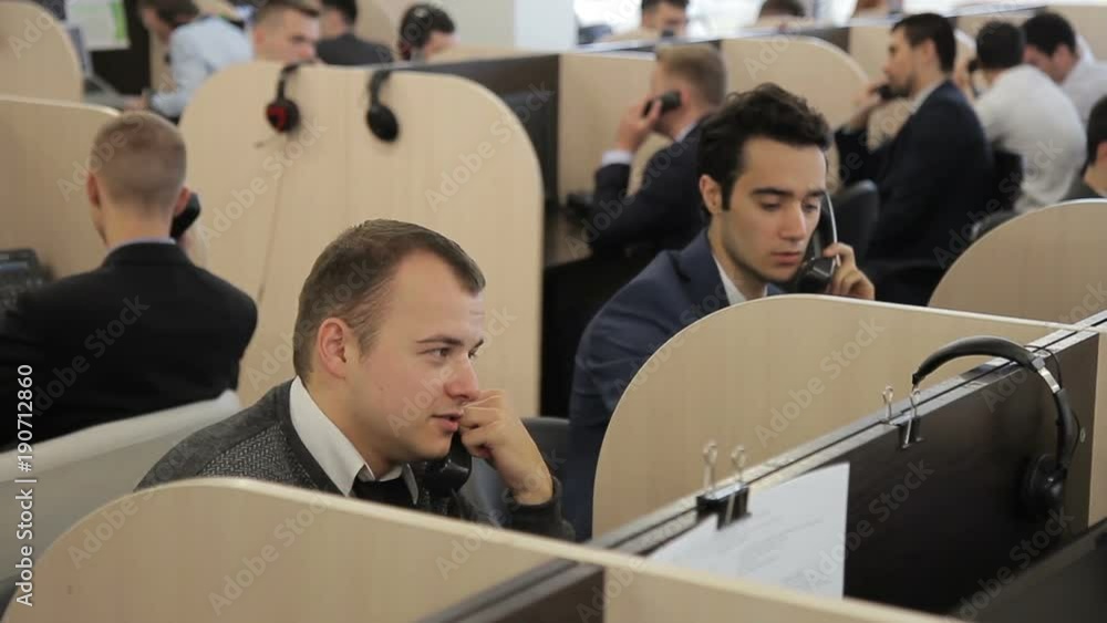 custom made wallpaper toronto digitalMale employees talk on phone in call center of company. Young people speak actively with customers, sitting on individual workstations separated by partitions. Promising specialists dressed in style