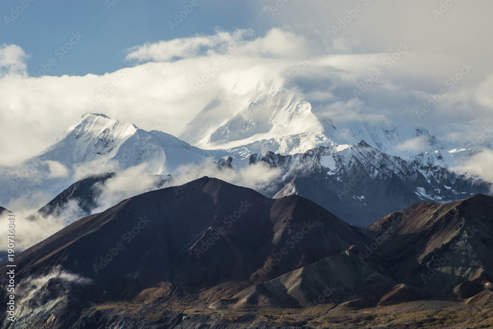 Mt. Denali rises above the smaller mountains in Alaska.