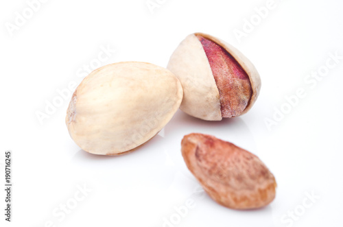 Fresh salthy pistachio nuts on white background