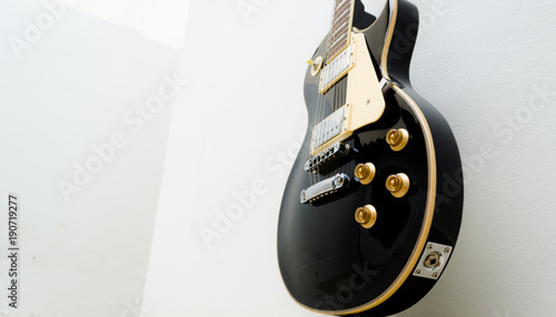 black guitar model les paul on a white background showing part of the body in a bottom view photo