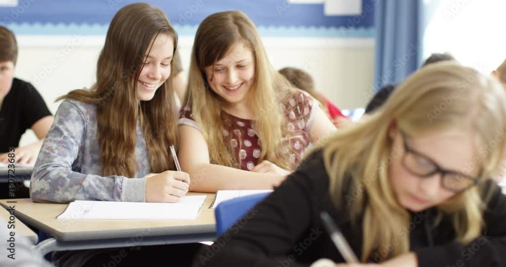 4k, Talkative school girls are caught whispering to each other during a class. 4k, Talkative school girls are caught whispering to each other during a class.