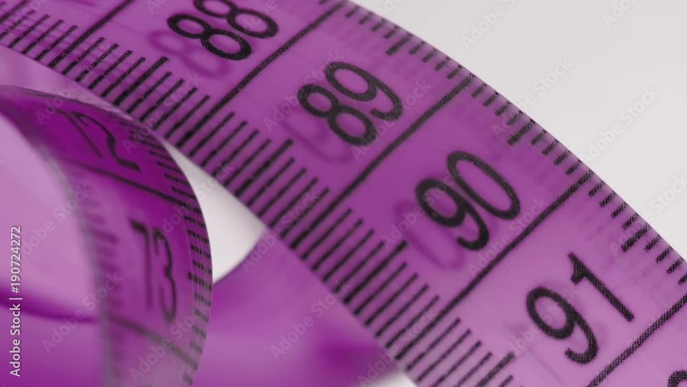 A ruler for measuring hips, chest and waist. standards of beauty in the world of modern fashion. Close-up, floating focus. A ruler for measuring hips, chest and waist. standards of beauty in the world of modern fashion. Close-up, floating focus.