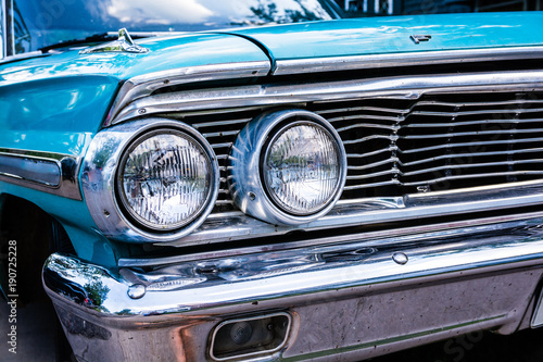 Blue Ford Galaxy 500 close up of grill and headlights