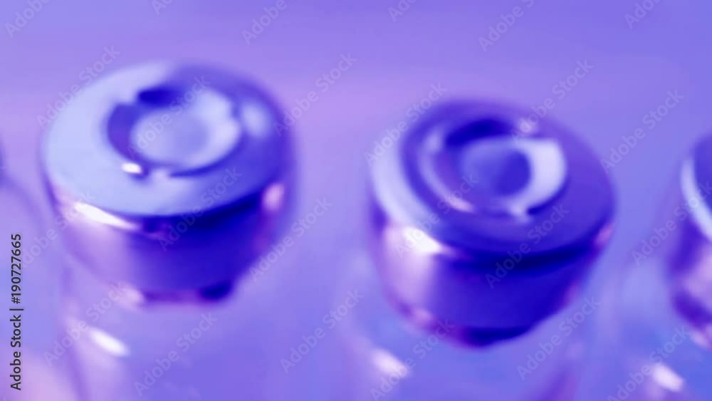 Manufacture of medicines. Vaccines for fever, rabies, flu, cancer. Vials and ampoules close-up. Manufacture of medicines. Vaccines for fever, rabies, flu, cancer. Vials and ampoules close-up.