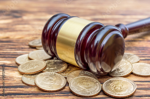 Judge's gavel with coins on the table. Close up. photo