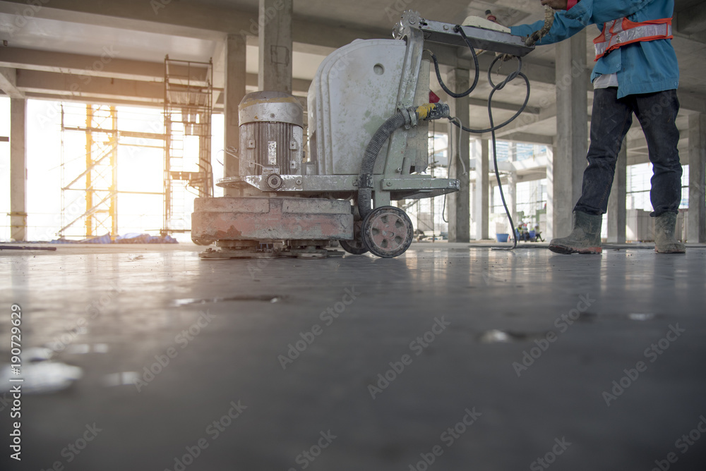 Construction worker produces the grout and finish wet concrete with a