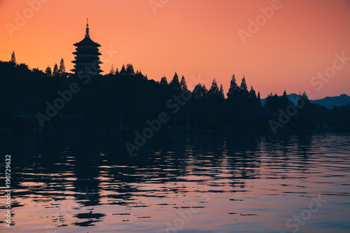 Silhouette of pagoda over bright evening sky