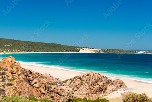 Desserted sandy beach with clear blue waters in summer