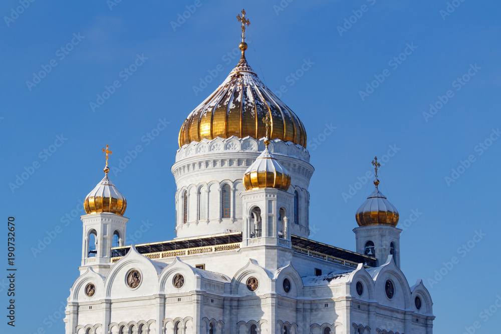 Cathedral of Christ the Saviour with golden domes in Moscow on a blue sky background at sunny winter day