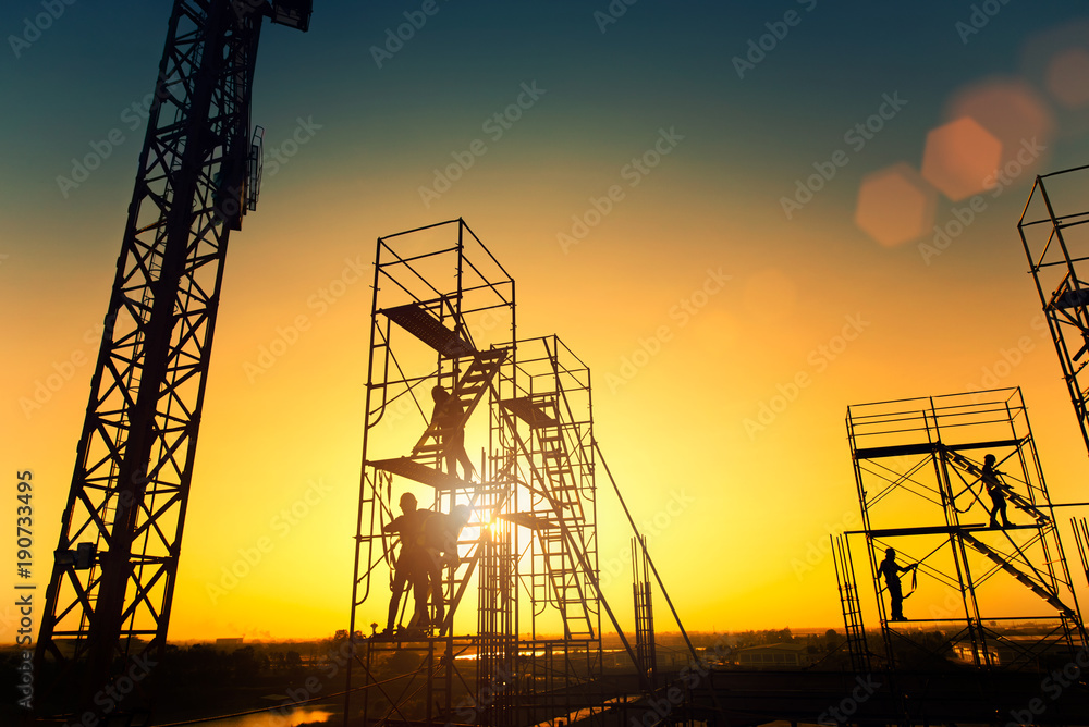silhouette construction worker Concrete pouring during commercial concreting floors of building in construction site and Civil Engineer or Construction engineer inspec work
