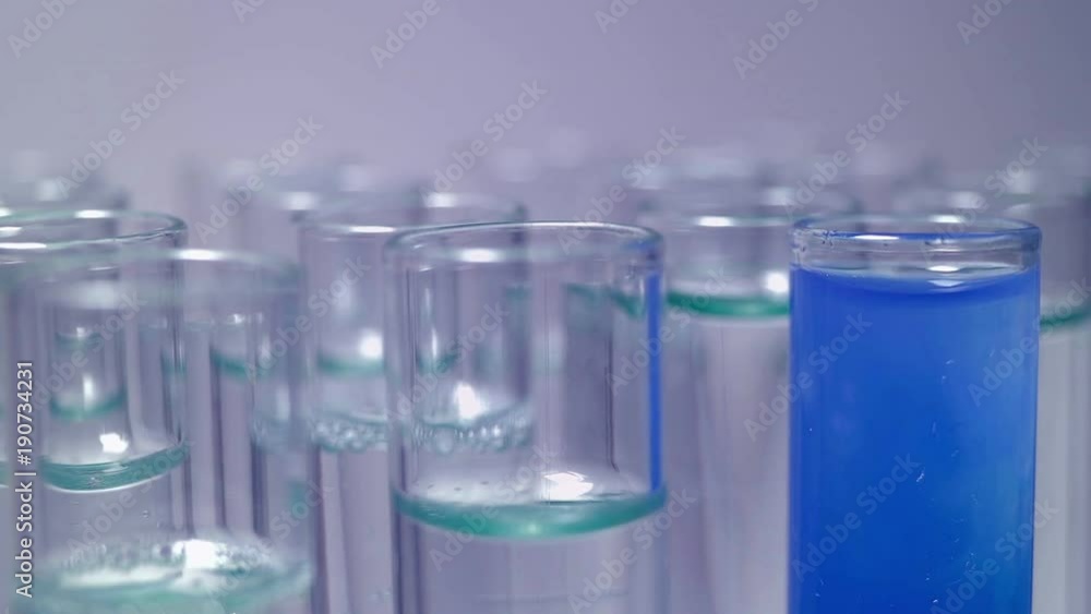 The panel with test tubes close-up. Genetics in yellow gloves makes a ...