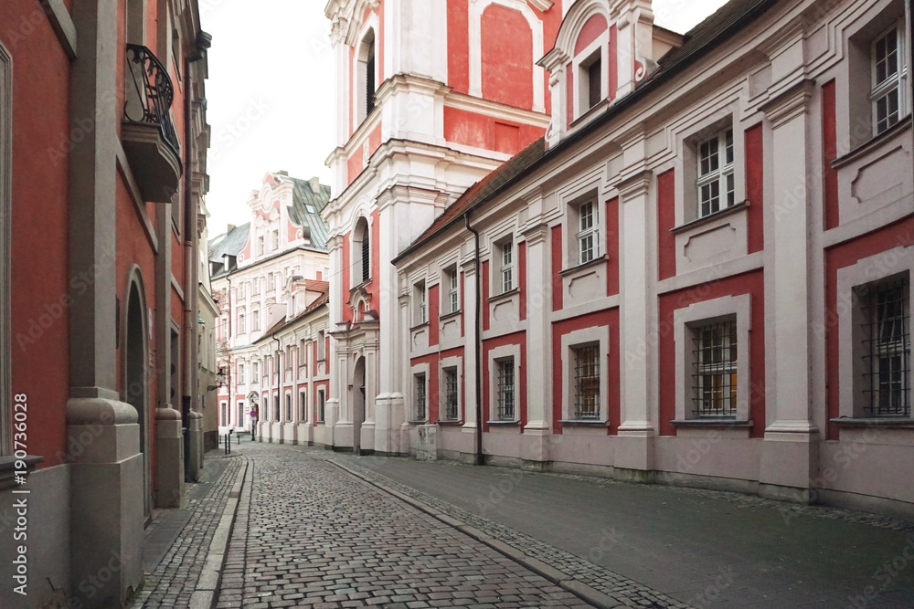 The ancient street of Poznan with the  monastery in perspective. Poland.